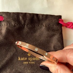 Kate Spade rose colored bracelet with the original bag